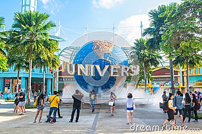 SINGAPORE - JANUARY 13 Tourists and theme park visitors taking pictures of the large rotating globe fountain in front of Universal Editorial Stock Photo