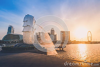 SINGAPORE-JULY 9, 2016: Merlion statue fountain in Merlion Park and Singapore city skyline at sunrise on July 9, 2016. Merlion fou Editorial Stock Photo