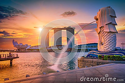 SINGAPORE-JULY 9, 2016: Merlion statue fountain in Merlion Park and Singapore city skyline at sunrise on July 9, 2016. Merlion Editorial Stock Photo