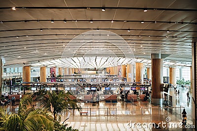 Singapore - June 2019 - Tourists and travellers wait in line to check in at Changi International Airport check in counters Editorial Stock Photo