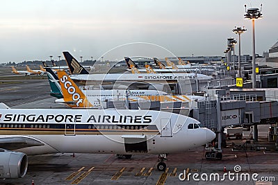 Singapore. March 2019. Changi International Airport. Terminal 2. Plane fleet at the airport. Planes are preparing for departure Editorial Stock Photo