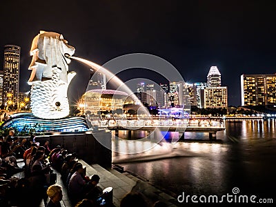 SINGAPORE - NOV 22, 2018: The Merlion fountain spouts water in front of the Marina Bay Sands hotel in Singapore. This fountain is Editorial Stock Photo