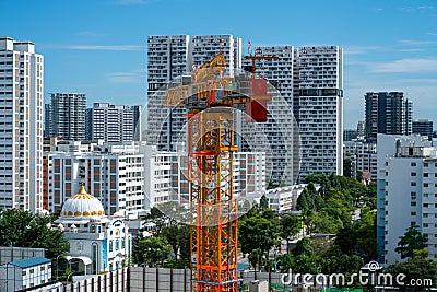 Construction crane against Singapore residential skyline Editorial Stock Photo
