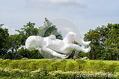 Planet bronze and steel sculpture showing white oversized baby in Gardens by the Bay in Singapore Editorial Stock Photo