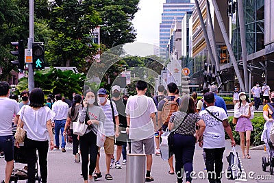Singapore Sep2020 People wearing face masks crossing a road selective focus. Crowd picks up in Orchard Road during Phase 2 after Editorial Stock Photo