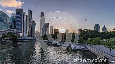 Singapore skyscrapers skyline with white Anderson Bridge near esplanade park day to night timelapse. Stock Photo