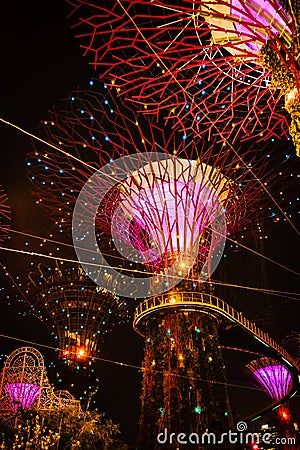 SINGAPORE: Supertrees and bridge illuminated for light show in gardens by the bay Editorial Stock Photo