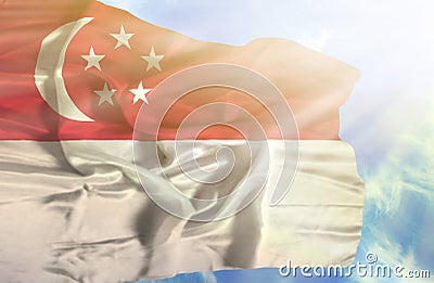 Singapore waving flag against blue sky with sunrays Stock Photo