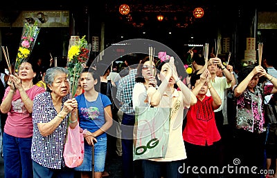 Singapore: Women Praying at Chinese Temple Editorial Stock Photo