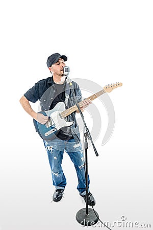 Singer Guitarist on White with hat strumming Stock Photo