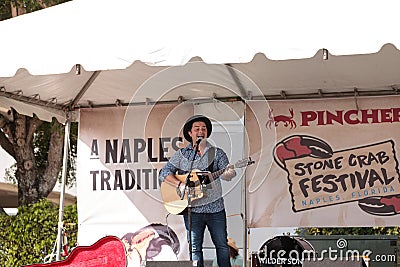 Singer Matty Jollie performs at the Naples Traditional Stone Crab Festival at Tin City Editorial Stock Photo