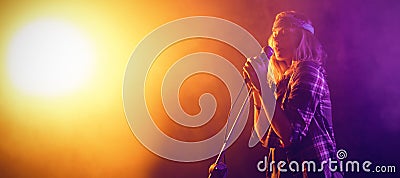 Singer performing at concert Stock Photo