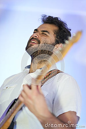 Singer plays the guitar while feeling the music inside Stock Photo