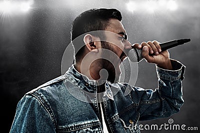 Singer singing rock song with microphone Stock Photo