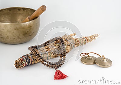 Singing Bowl, Smudge Stick, Prayer Beads and Meditation Bells. Stock Photo