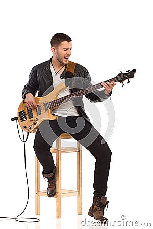 Singing guitarist with bass guitar. Stock Photo