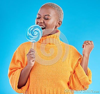Singing, lollipop and a woman with candy in studio for sweets, rainbow and creative advertising. Happy black female Stock Photo