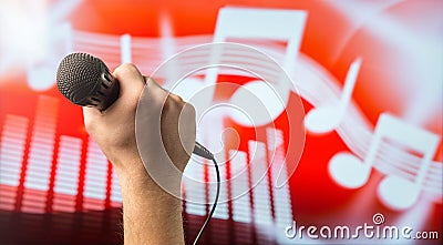 Singing microphone in hand Stock Photo