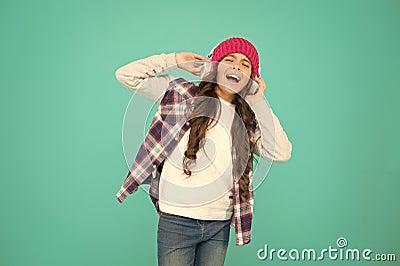 singing with mp3 player. small child long hair enjoy stereo. happy childhood. happy girl turquoise background. smiling Stock Photo