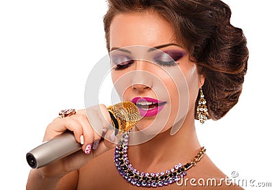 Singing Woman with Microphone.Glamour Singer Girl Portrait. Karaoke Song Stock Photo