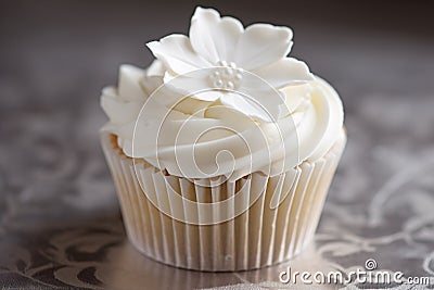 Single beautiful wedding cupcake with white sufar icing flower Stock Photo