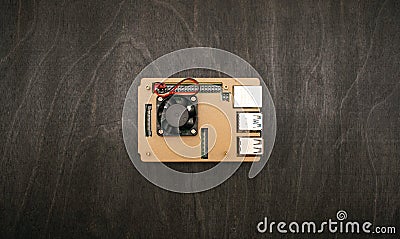 A single-board micro-computer in a case with a fan stands on a table, top view shot Stock Photo