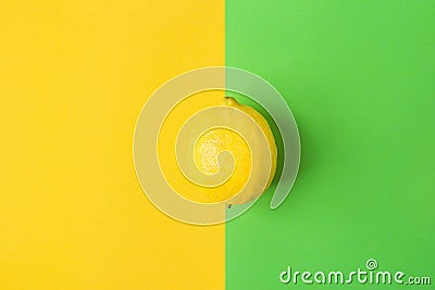 Single Bright Ripe Lemon on Contrast Background from Combination of Yellow Green Colors. Styled Creative Image. Stock Photo