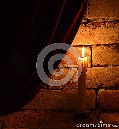 Single burning candle Stock Photo