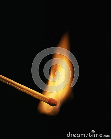 Single burning match on black background Stock Photo