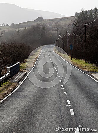 Single carriageway road into distance Stock Photo