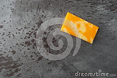 Single Colby Jack cheese bar offset on a gray background top view Stock Photo