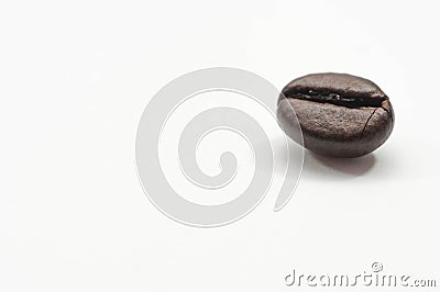 Single, cracked coffee bean close up macro . Stock Photo