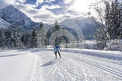Single cross country skier on groomed ski track. Stock Photo