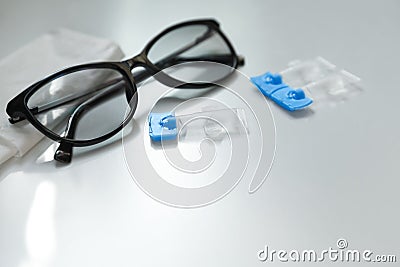 Single dose eye drops, glasses and fabric on table. Space for text Stock Photo