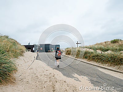 Single Dutch woman walking to the beach Editorial Stock Photo