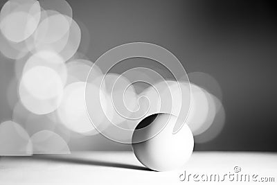 Single egg isolated from white background with bokhe. Black and white concept Stock Photo