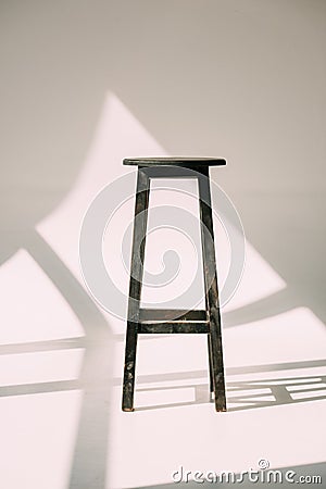 single empty tall wooden stool Stock Photo