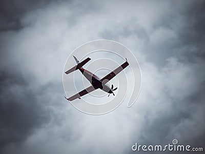 A single-engine turboprop airplane flaying against blue cloudy sky Editorial Stock Photo