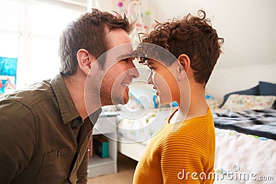 Single Father Head To Head At Home With Son In Bedroom At Home Stock Photo