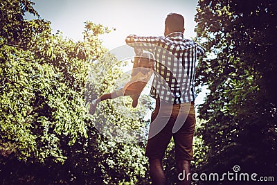 Single father playing in the meadow with daughter. Stock Photo