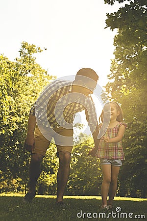 Single father running in the meadow with daughter. Stock Photo