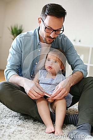 Single father wit his daughter using smart phone. Stock Photo