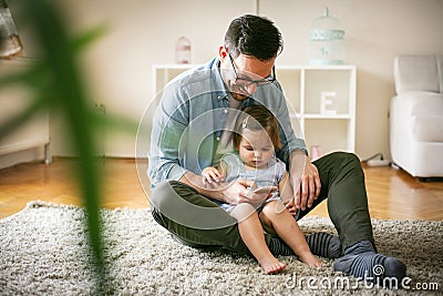 Single father wit his daughter using smart phone. Stock Photo