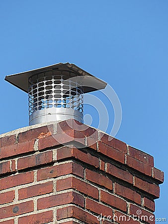 Single Flue Chimney Cap Close up Atop a Red Brick Chimney Stock Photo