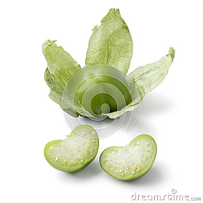 Single fresh green whole and halved tomatillo in a husk on white background Stock Photo
