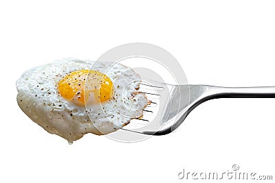 Single fried egg sprinkled with ground black pepper resting on m Stock Photo