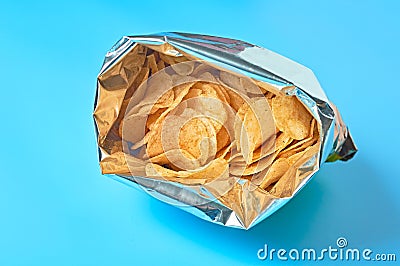 Single full shiny packaging of potato chips on blue background Stock Photo