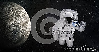 Single giant astronaut in outer space near tiny Earth and moonlike planet. Elements of this image were furnished by NASA. Stock Photo