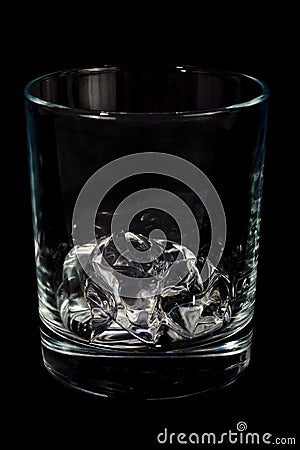 Single glass with ice cube Stock Photo