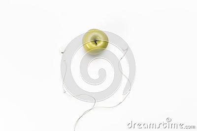 Single green color apple and digital audio headphones Stock Photo